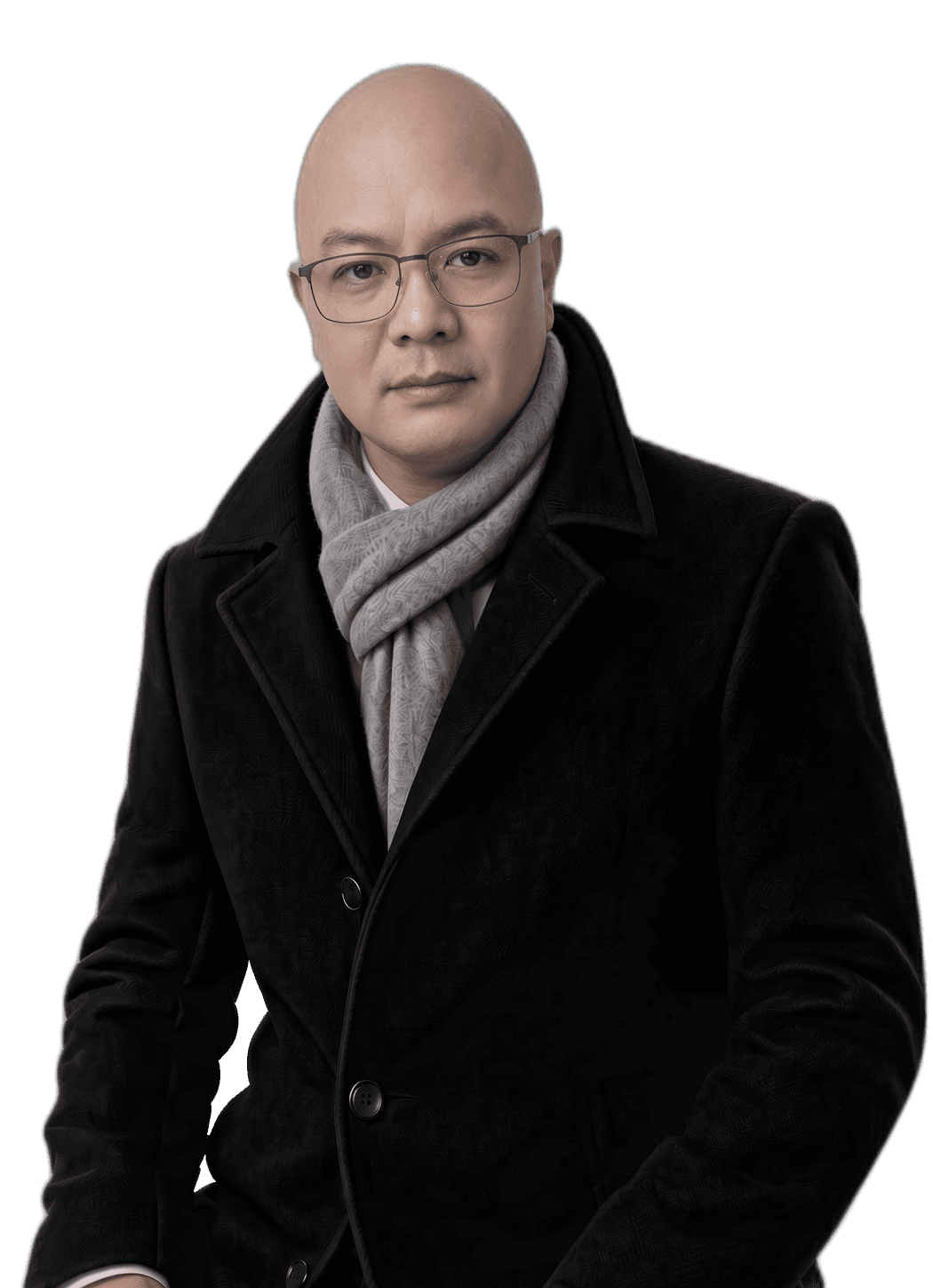 Portrait of Villar David wearing glasses, a grey scarf and a black tailored overcoat